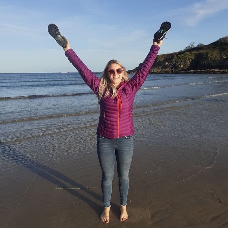 Claire on a UK beach in Cornwall, testing whether a portable income could actually go anywhere